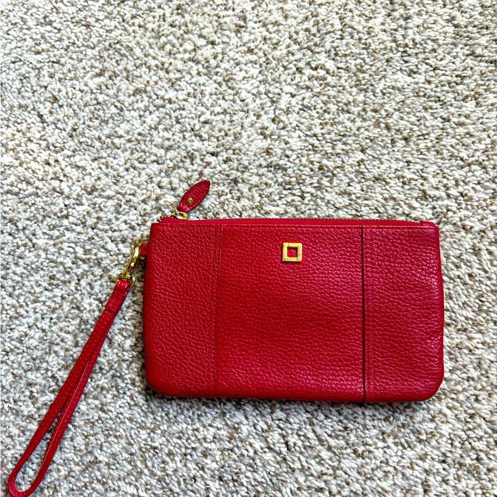 Lodis Red Wristlet with geometric black pattern inside.